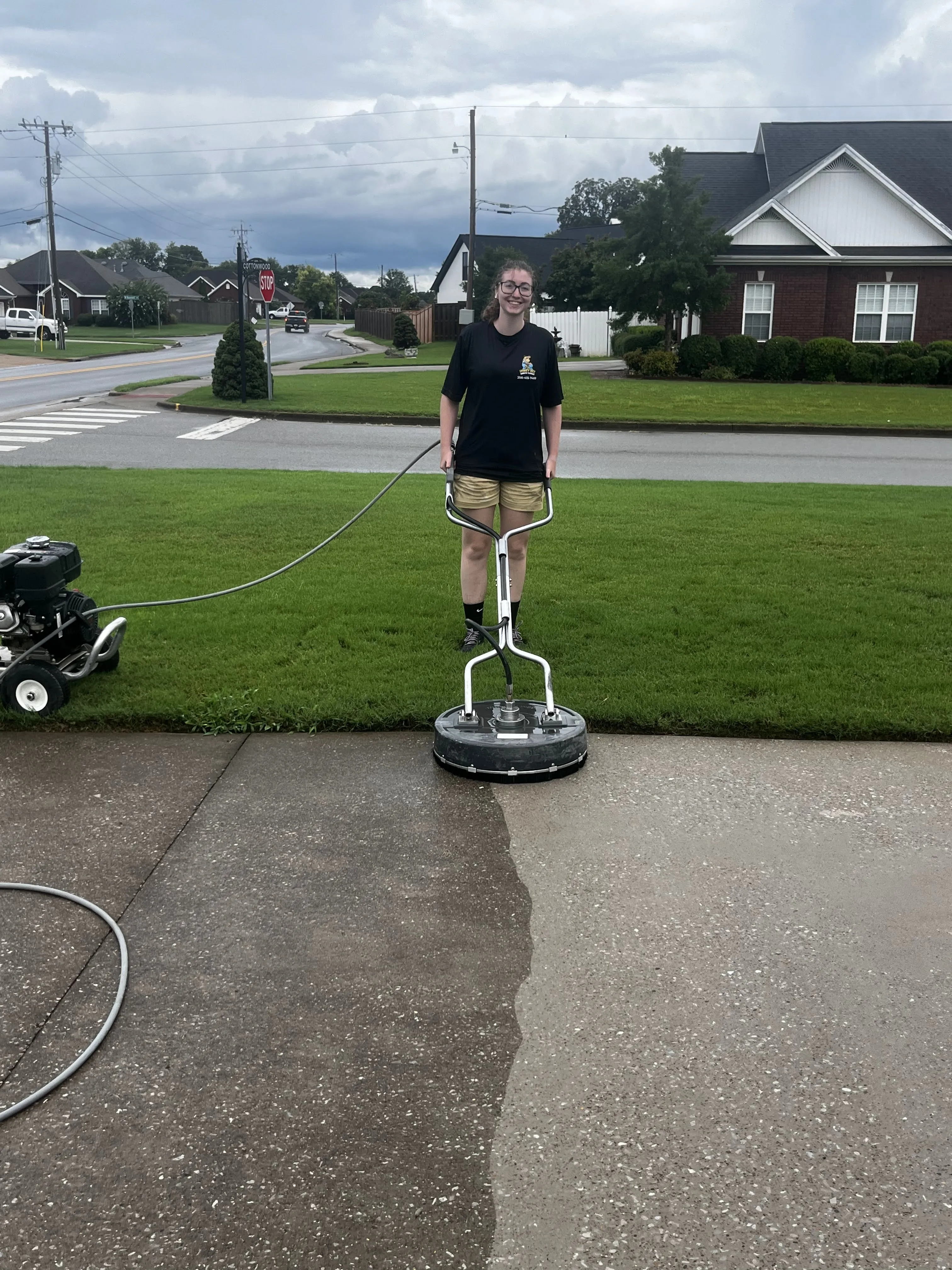 Concrete driveway dark with mildew and grime before pressure washing