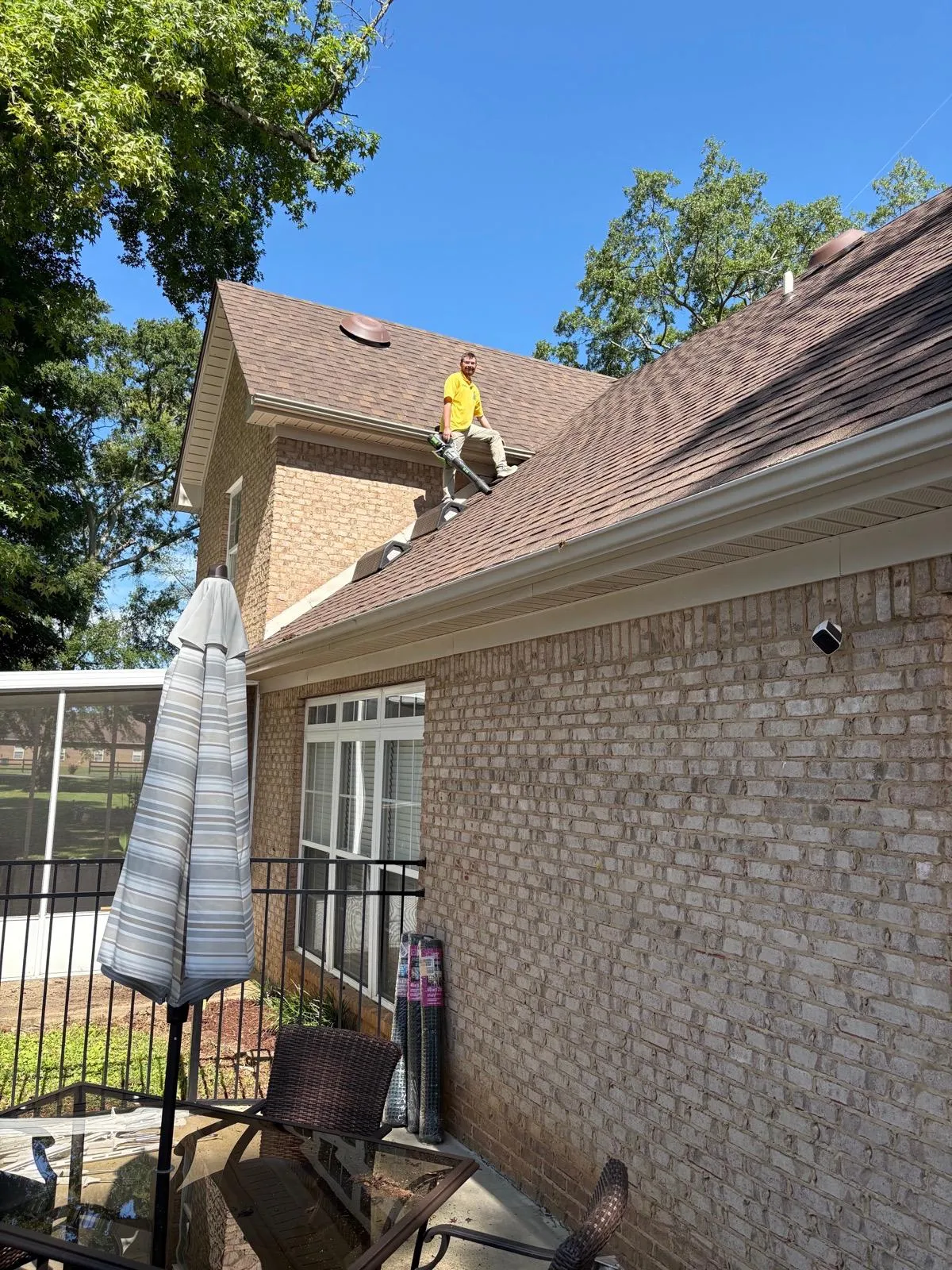 HoneyBee technician on a residential roof during a soft wash