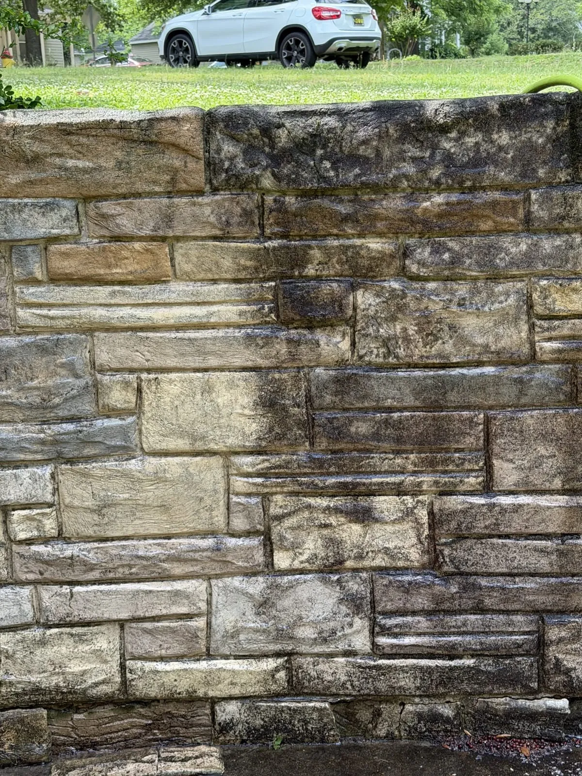 Stone wall rinsed clean after HoneyBee soft washing